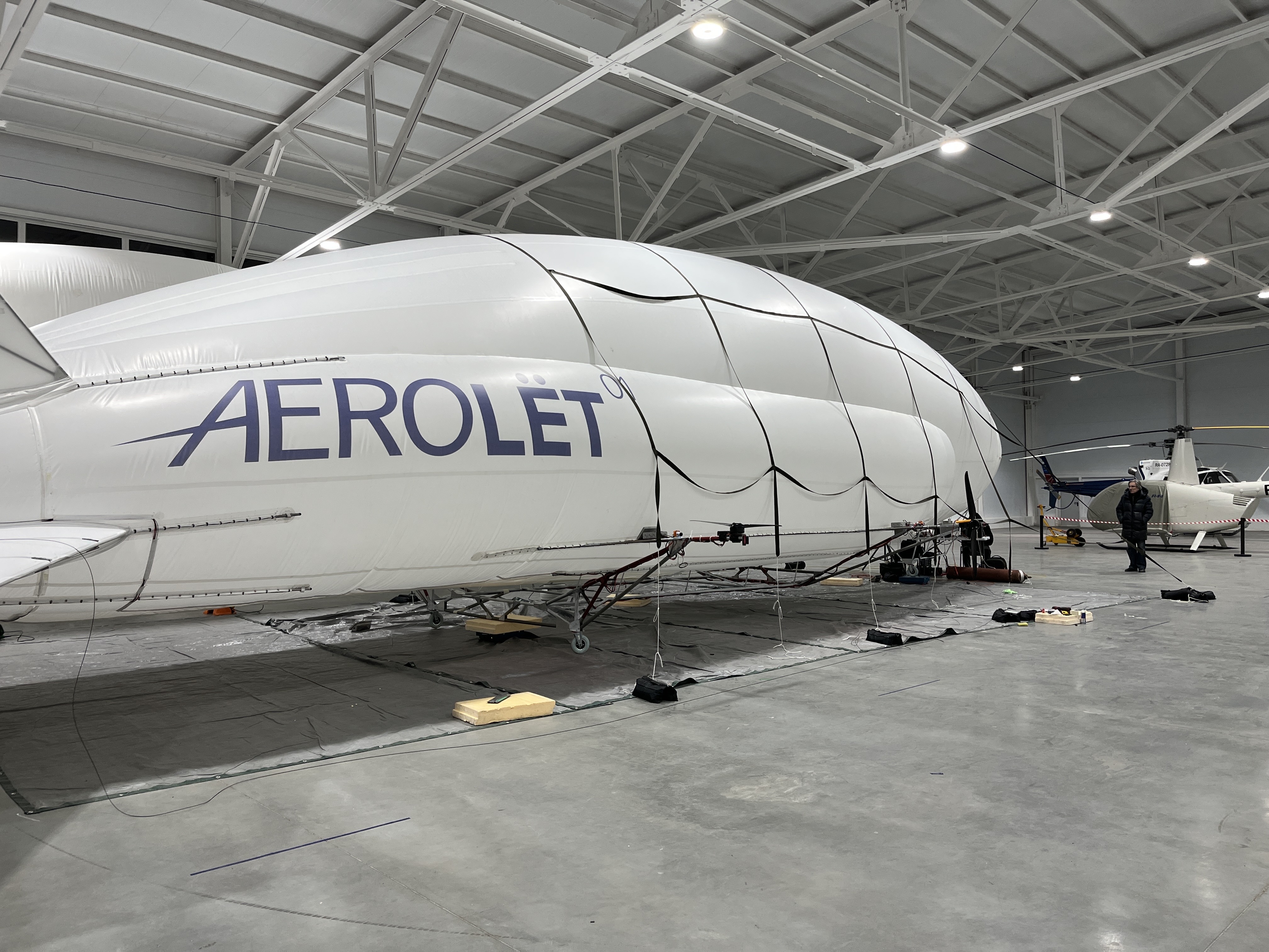 Aerolyot-01 · inflated in the hangar next to helicopter (scale reference)