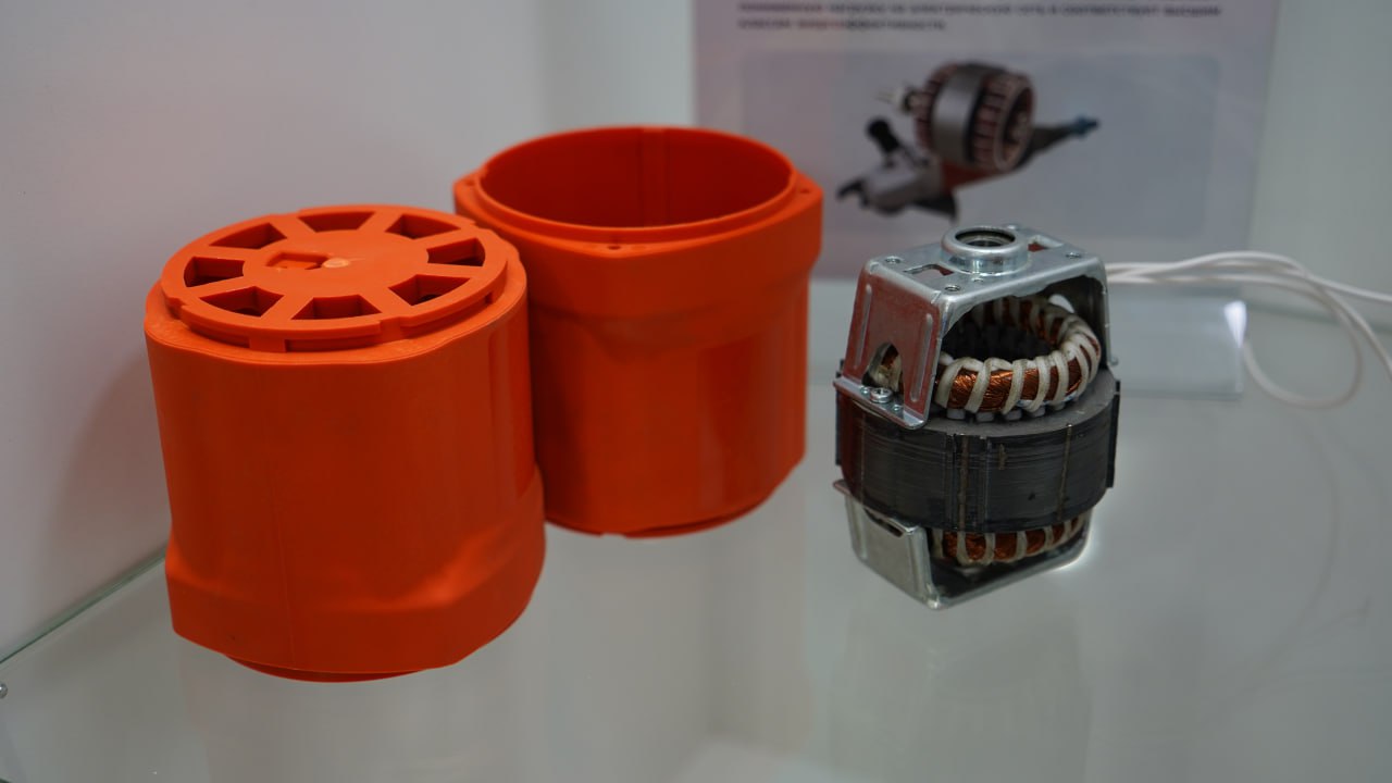 Disassembled angle-grinder · orange housings and Slavyanka motor stator