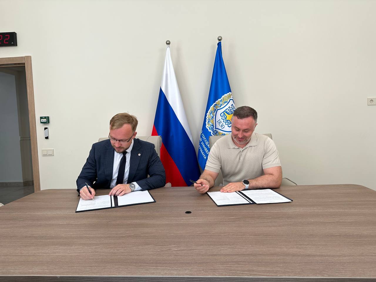 Formal signing at the negotiation table.