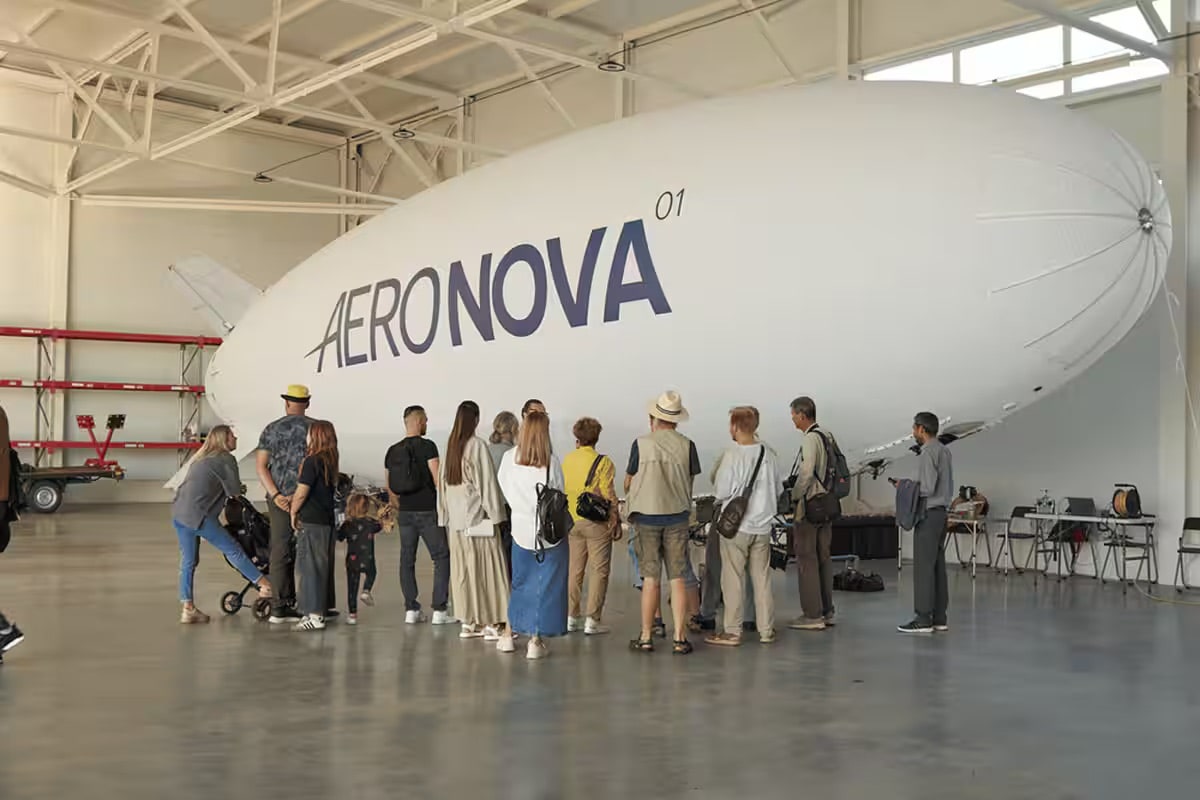 Visitors inspect NOVA-01 inside the AERONOVA hangar before the field demonstration.