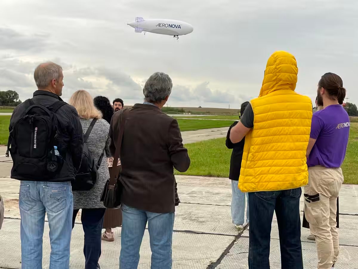 Investors and partners watch NOVA-01 in flight at the Voskresensk airfield.